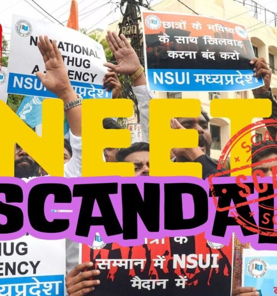 A protest scene with multiple individuals holding banners regarding a ‘NEET SCANDAL’, with large overlaid text stating ‘NEET SCANDAL’ at the center. Some visible texts include acronyms ‘NSUI’, ‘NTA’, and an explanation for ‘NEET’. Top left corner has a red stamp marked ‘FAKE’. Faces are pixelated for privacy.